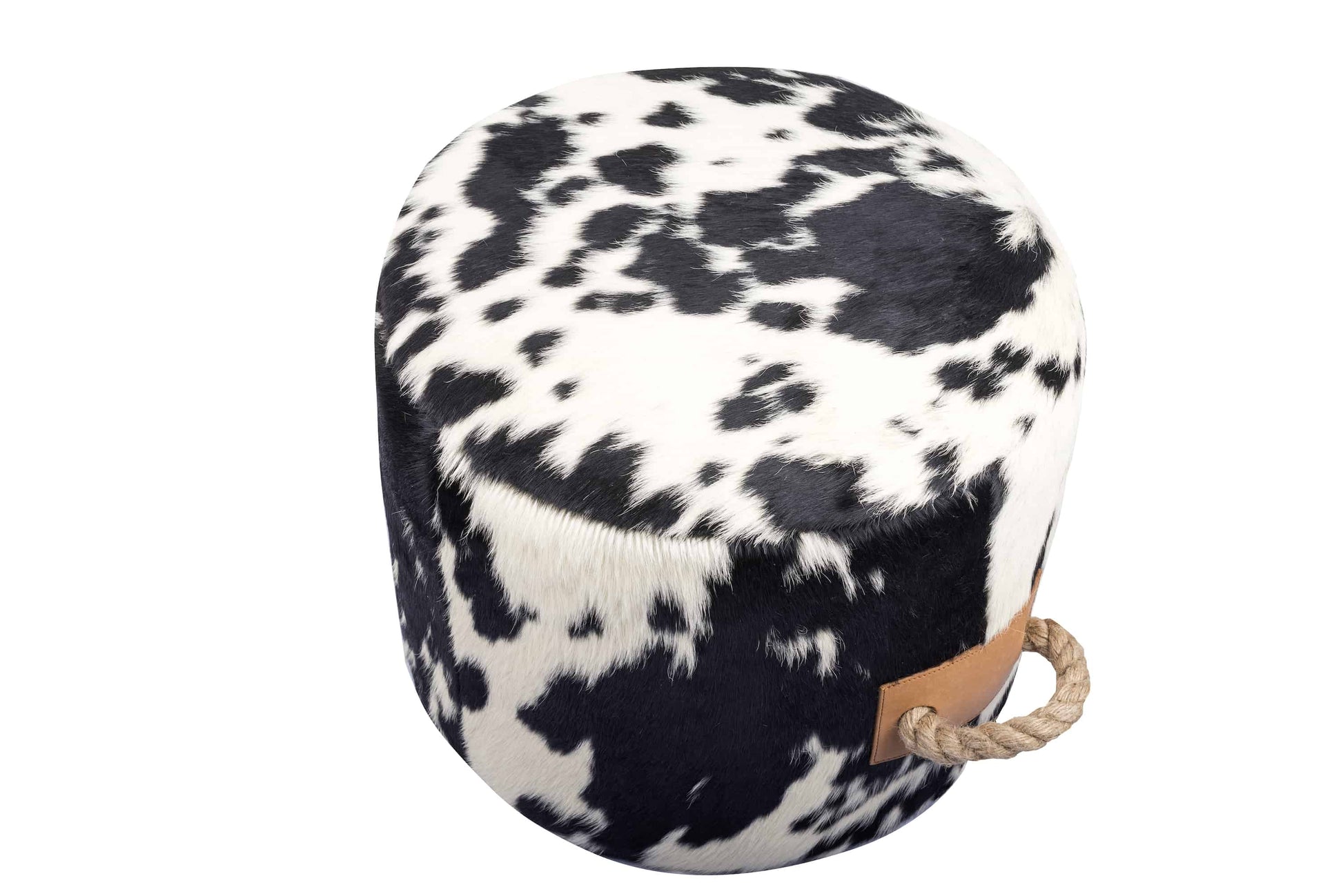 round cowhide ottoman with a natural black and white spotted pattern and tan leather tabs on the sides with thick, jute handles